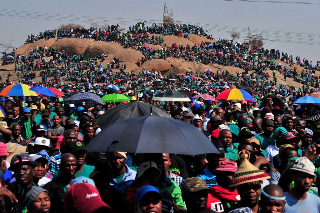 People gather during an event to commemorate the sixth anniversary of the Marikana massacre in 2018.