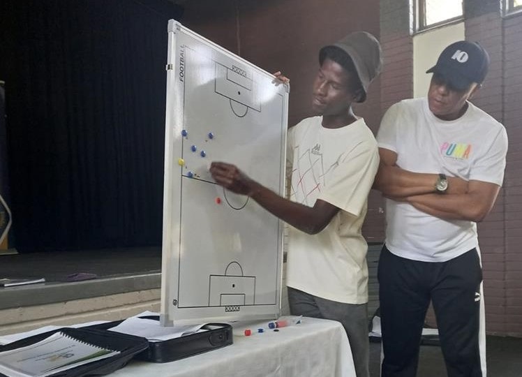 Doctor Khumalo watches on as an aspirant coach shares what he learnt during a coaching workshop in Soweto