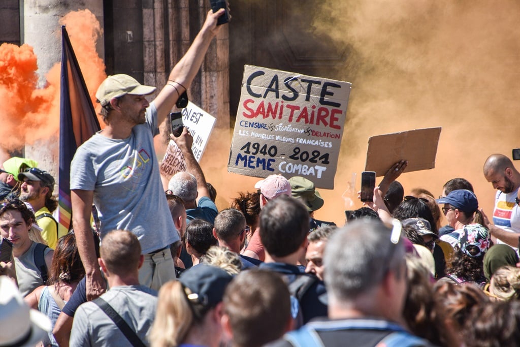 Protesters display placards against the health pass during a demonstration in front of town hall in Marseille. (Photo by Gerard Bottino/SOPA Images/LightRocket via Getty Images)