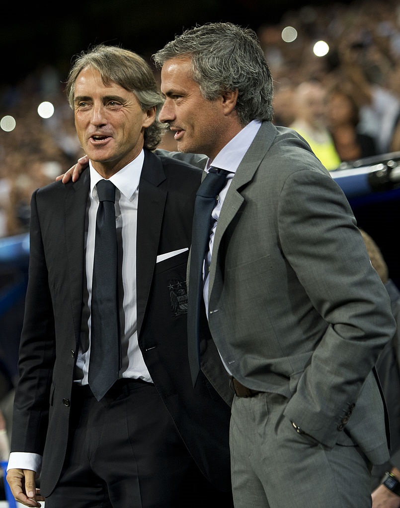 MADRID, SPAIN - SEPTEMBER 18:  Head coach Jose Mourinho (R) of Real Madrid greats head coach Roberto Mancini of Manchester City FC during the UEFA Champions League group D match between Real Madrid and Manchester City FC at the Estadio Santiago Bernabeu on September 18, 2012 in Madrid, Spain.  (Photo by Jasper Juinen/Getty Images)