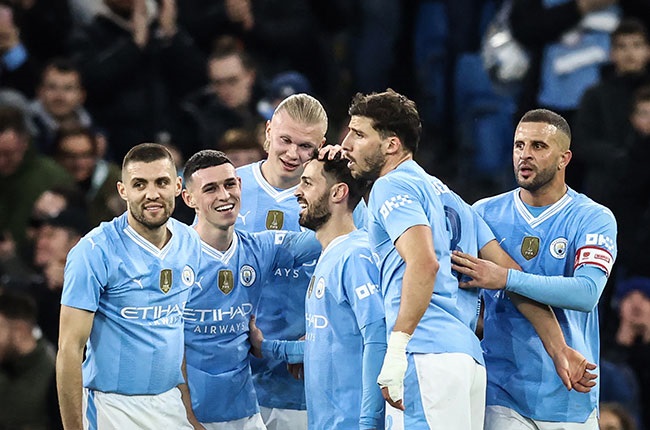 Manchester City's midfielder Bernardo Silva celebrates with teammates after scoring a goal at the Etihad Stadium in Manchester. (Photo by Darren Staples / AFP)
