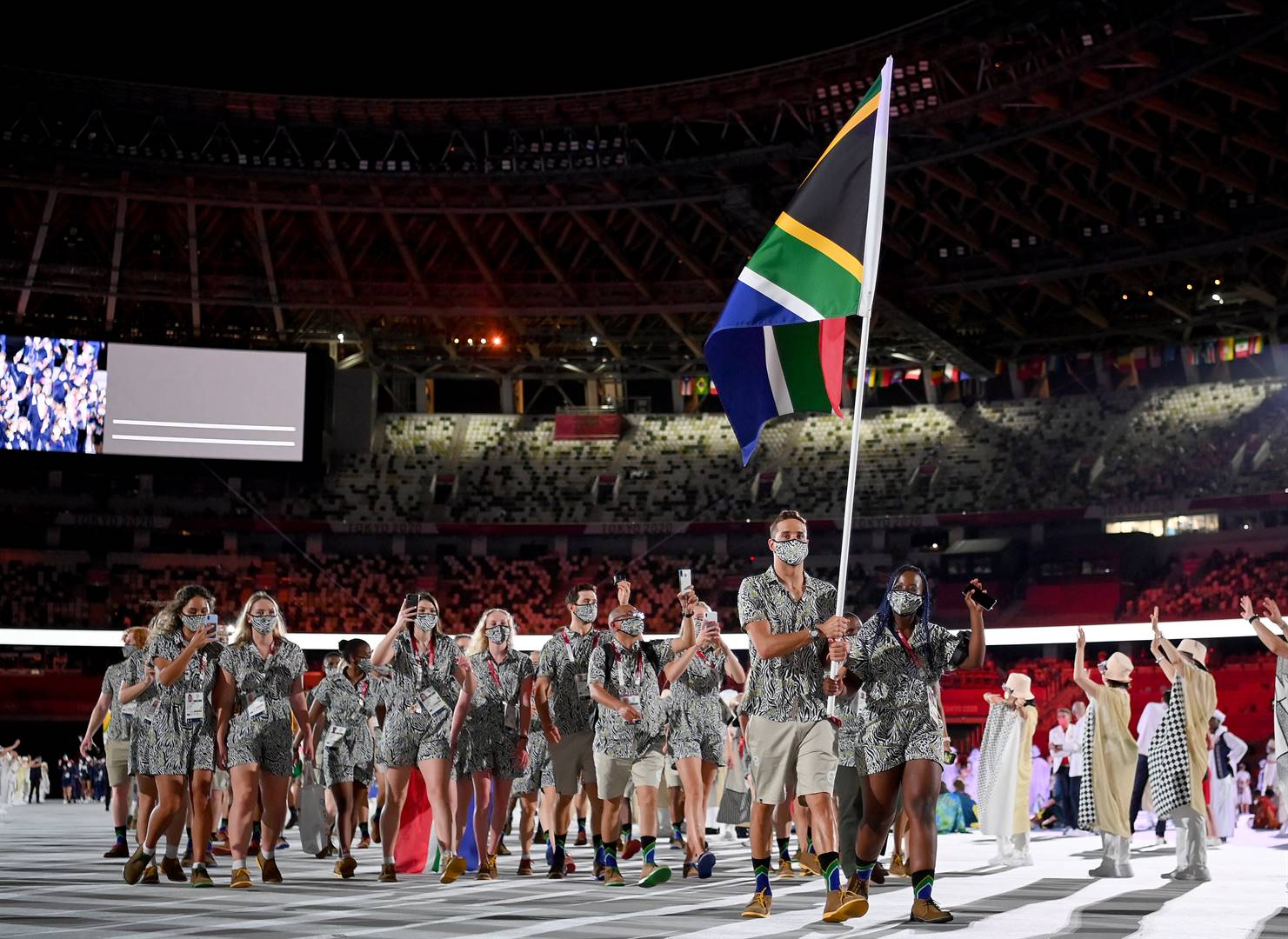 Phumelela Luphumlo Mbande and Chad le Clos lead Team SA into the arena at Olympic Stadium during the opening ceremony of the Tokyo 2020 Olympic Games on Friday. Photo: Matthias Hangst/Getty Images