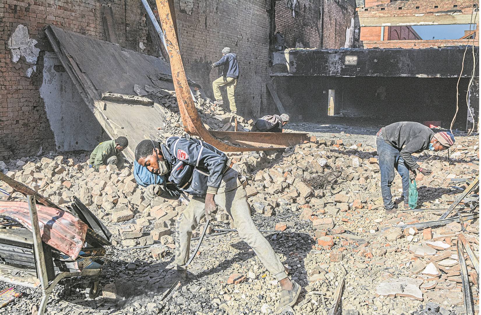 Recyclers are removing the scrap metal from buildings that were burnt during the recent unrest in the Pietermaritzburg CBD.