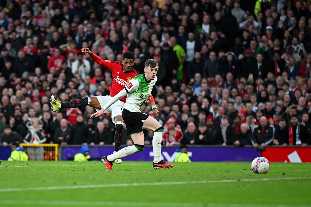 Amad Diallo of Manchester United scores his team's fourth goal while under pressure from Conor Bradley of Liverpool during the FA Cup quarter-final at Old Trafford on 17 March 2024 in Manchester, England. (Michael Regan/Getty Images)