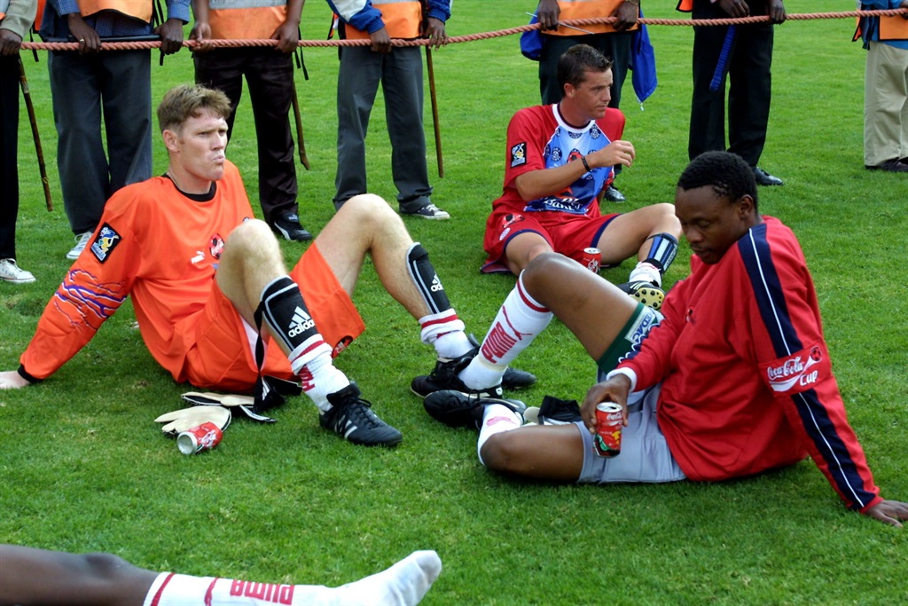 24 November 2001.Coca Cola Cup Final. Kaizer Chiefs 5 vs Jomo Cosmos 0 at FNB Stadium. Jomo Cosmos players sitting after their defeat. Digital Image. Photo Credit: - Gallo Images.