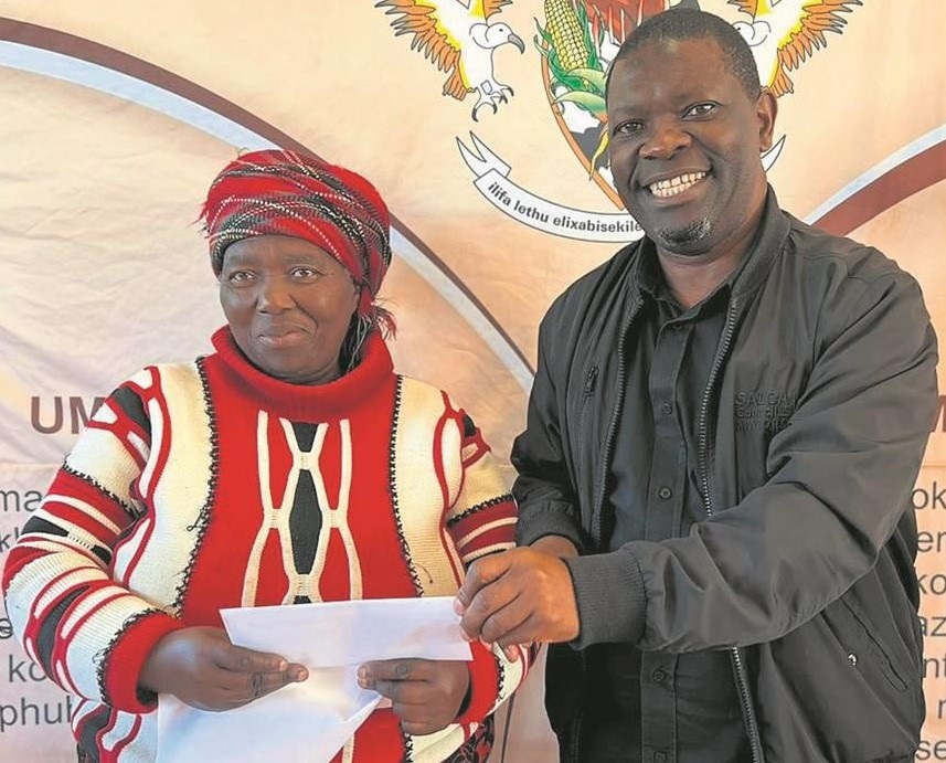 Mbhashe Local Municipality executive mayor Samkelo Janda handing over a voucher to an informal business owner, during the municipality's disbursement of informal business support vouchers to informal traders from Idutywa.                                        