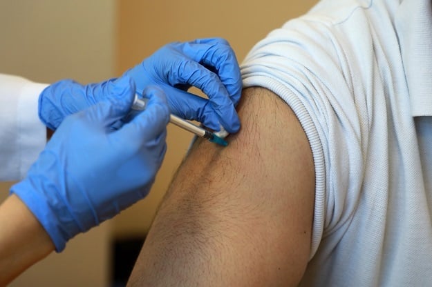 A health worker administers a shot of the Pfizer Covid-19 vaccine shot. 