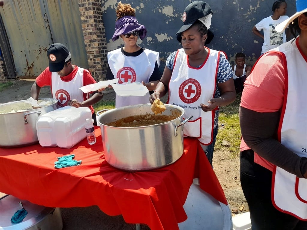 Red Cross volunteers in Gauteng feeding the poor in Soweto.