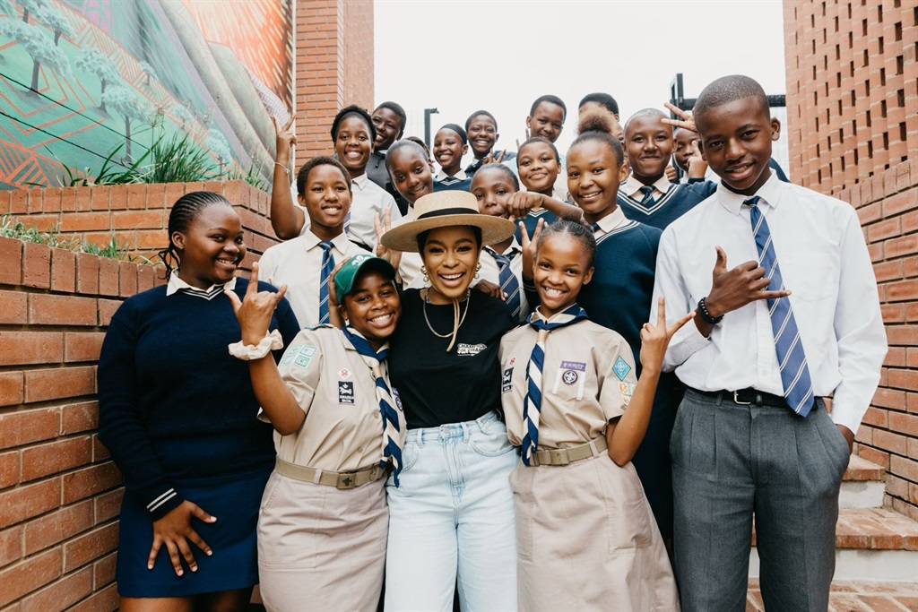 Actress Nomzamo Mbatha (middle) and pupils from Dr JL Dube High School have a reason to be happy. Photo by Kgalalelo Tlhoaele