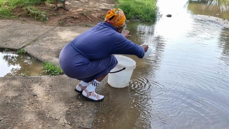 A resident fetching water from the dam.  Photo by Joseph Mokoaledi.