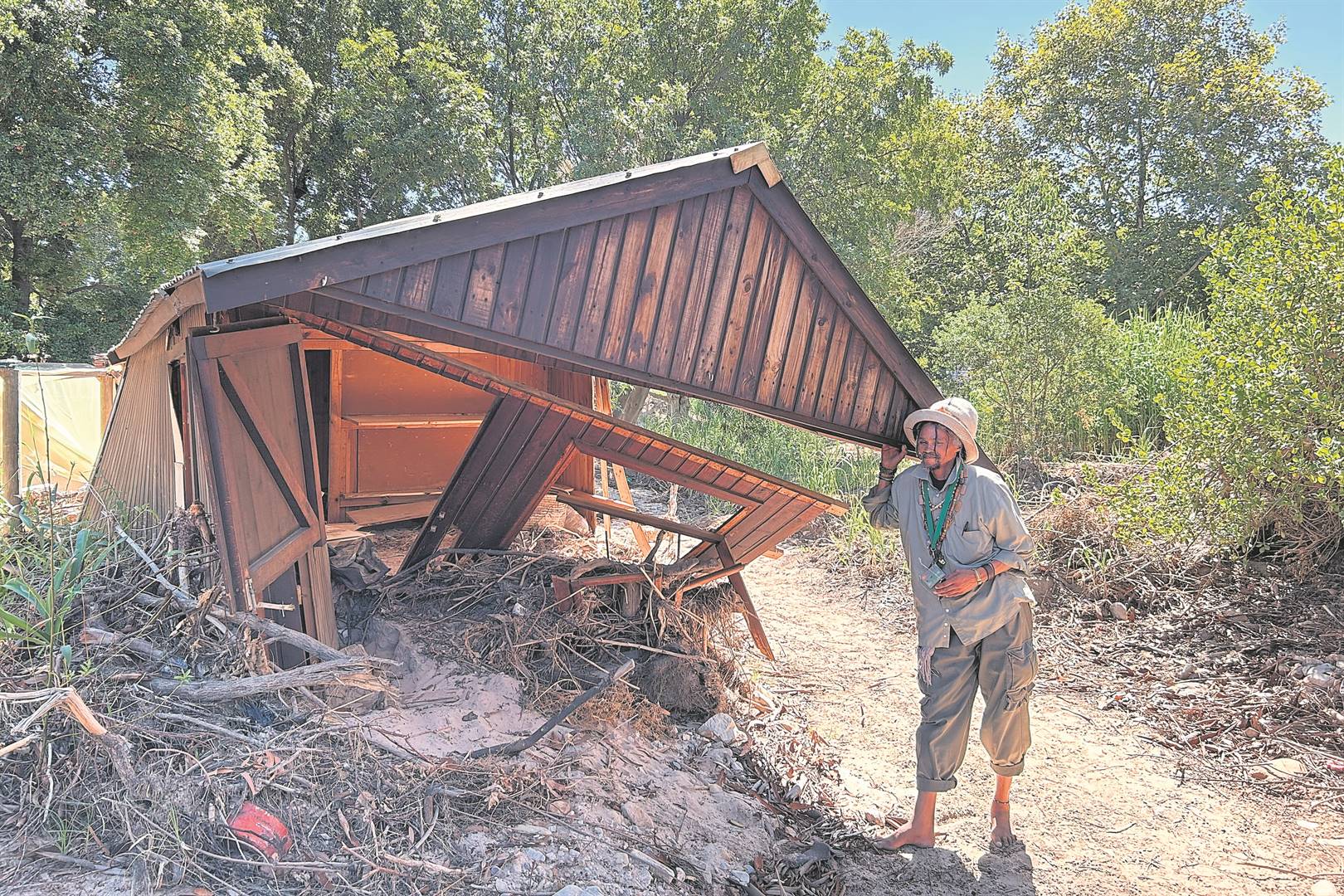 Judah James (51) next to his ruined wendy house in the middle of the botanical garden, which was damaged in the September floods last year.Photos: Rasaad Adams