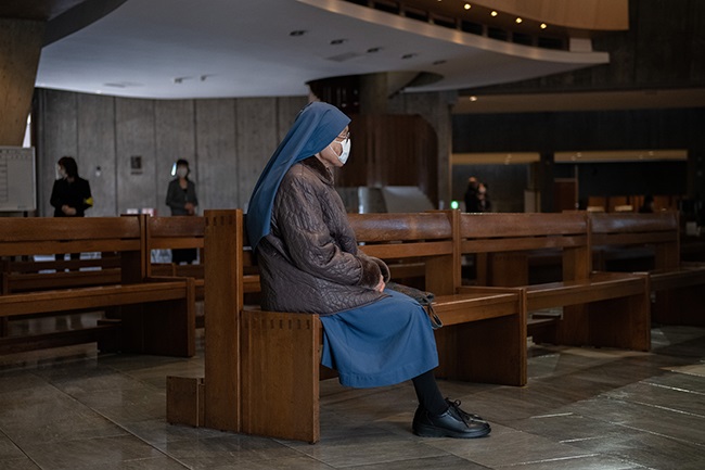 TOKYO, JAPAN - DECEMBER 25: A nun wears one more face