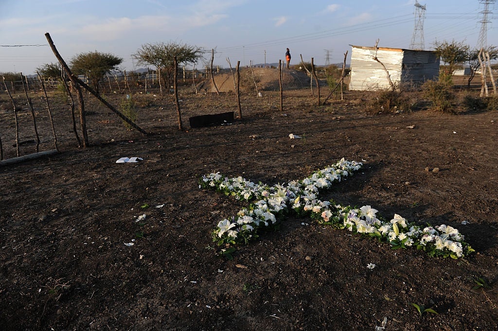 A remembrance cross made of flowers is seen during a of the 2012 Marikana massacre.