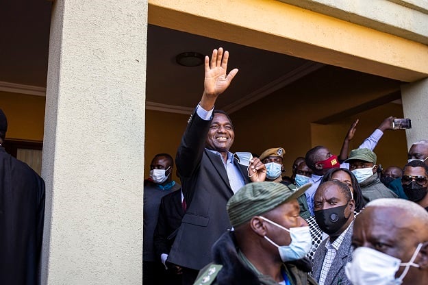 President elect Hakainde Hichilema waves at supporters after a press briefing at his residence in Lusaka. 