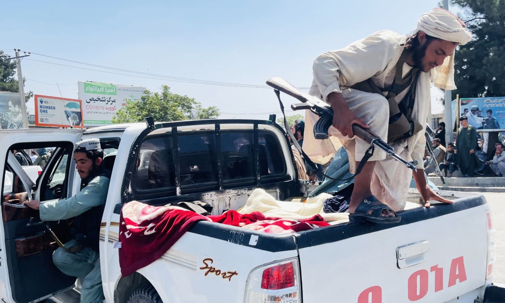 Taliban members are seen near Hamid Karzai International Airport as thousands of Afghans rush to flee the Afghan capital of Kabul.  