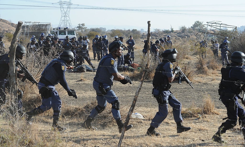 Police officers open fire on striking mineworkers outside the Nkageng informal settlement in Marikana on 16 August 2012.