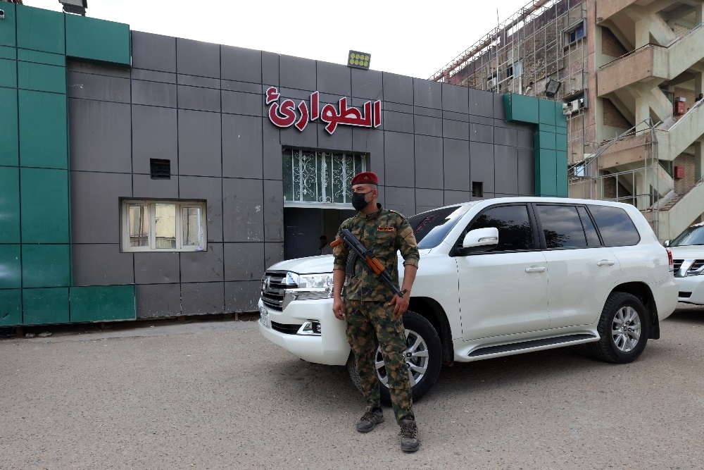 A soldier stands guard at the entrance of a hospital in central Iraq where people wounded in an overnight blast are being treated. (Karar Jabbar/AFP)