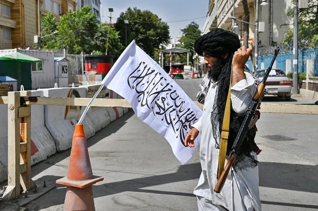 A Taliban fighter patrols along a street in Kabul after the group took over the city.