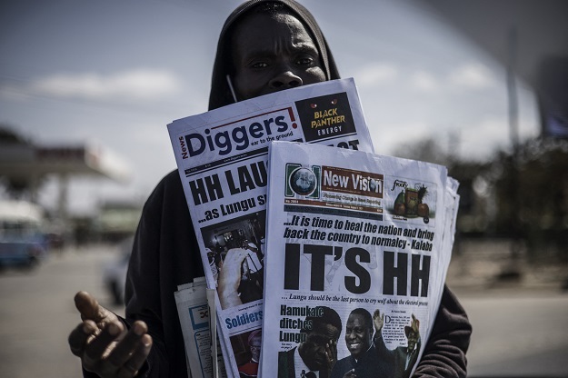 A newspaper vendor is seen carrying Zambian dailies in Lusaka, on Monday.