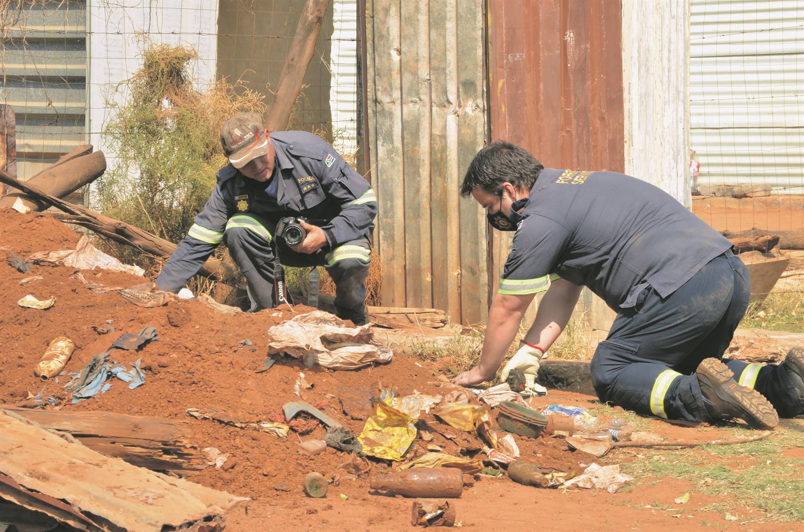 GRUESOME SCENE: Cops and the forensic team dig up body parts at different places in Ledig last week Friday.                Photos by Rapula Mancai