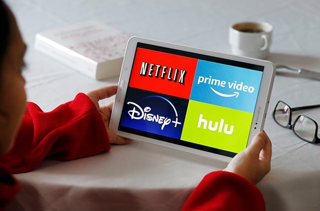  In this photo illustration, the logos of media service providers, Netflix, Am.azon Prime Video, Disney + and Hulu are displayed on the screen of a tablet.