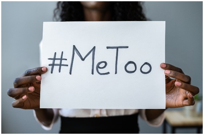 Woman holding a #MeToo movement placard.