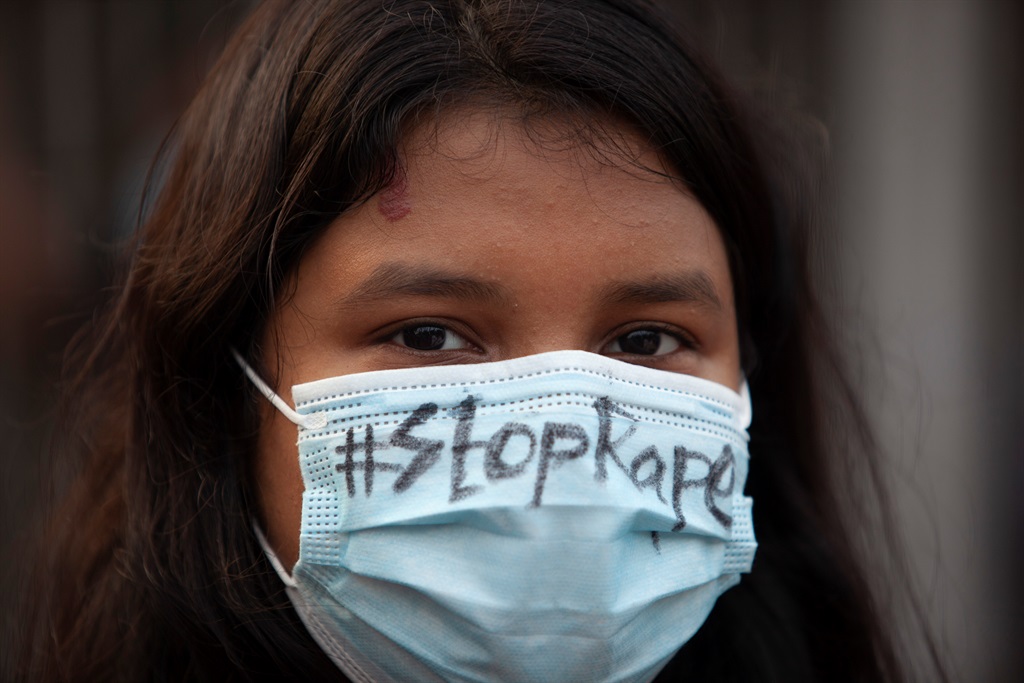 A protester wearing a face mask saying, stop rape, during the demonstration.