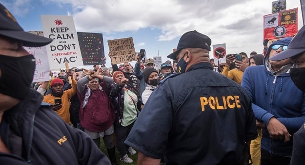 Police monitor a protest against vaccine passports in Cape Town.