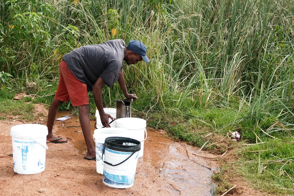 Moutse, Limpopo, resident Meshack Mtsweni filling buckets with water at borehole. (Jan Gerber/News24)