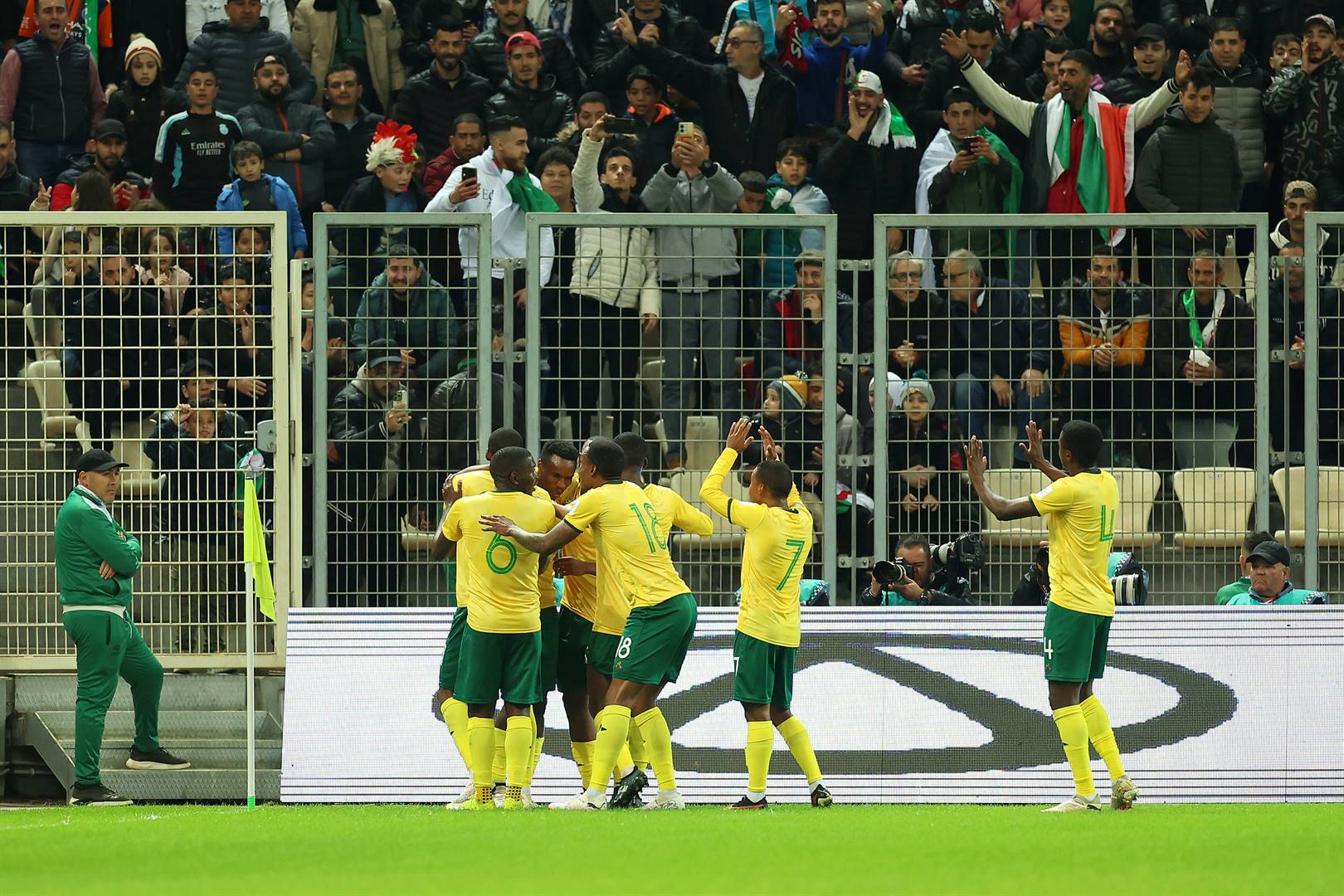 Themba Zwane of South Africa celebrates with teammates after scoring his team's first goal during the FIFA Series 2024 clash against Algeria at the Nelson Mandela Stadium on 26 March 2024 in Algiers, Algeria. (Richard Pelham - FIFA/Getty Images)