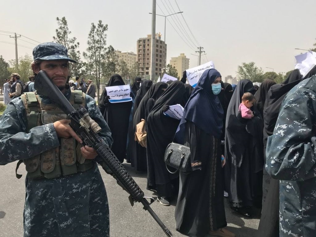 Taliban take measures during a march as women take part in to support Taliban in Kabul.  