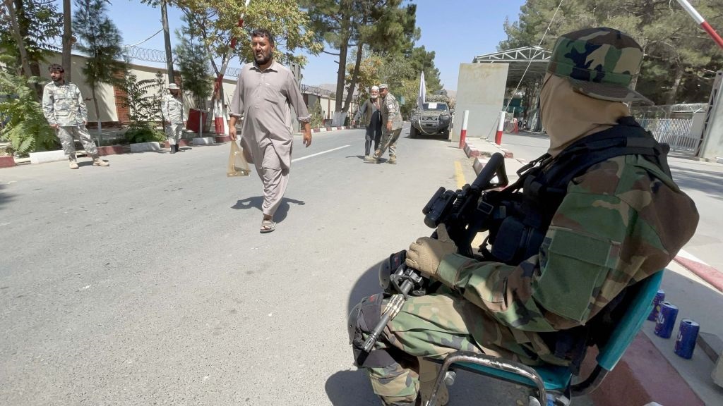 Passengers walk as they go to the terminal at Hamid Karzai International Airport in Kabul, Afghanistan.  