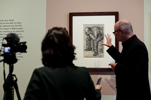 A journalist records image and explanations in front of a newly discovered work by Vincent van Gogh 'Study for Worn' out from 1882, displayed at the Van Gogh Museums in Amsterdam.
