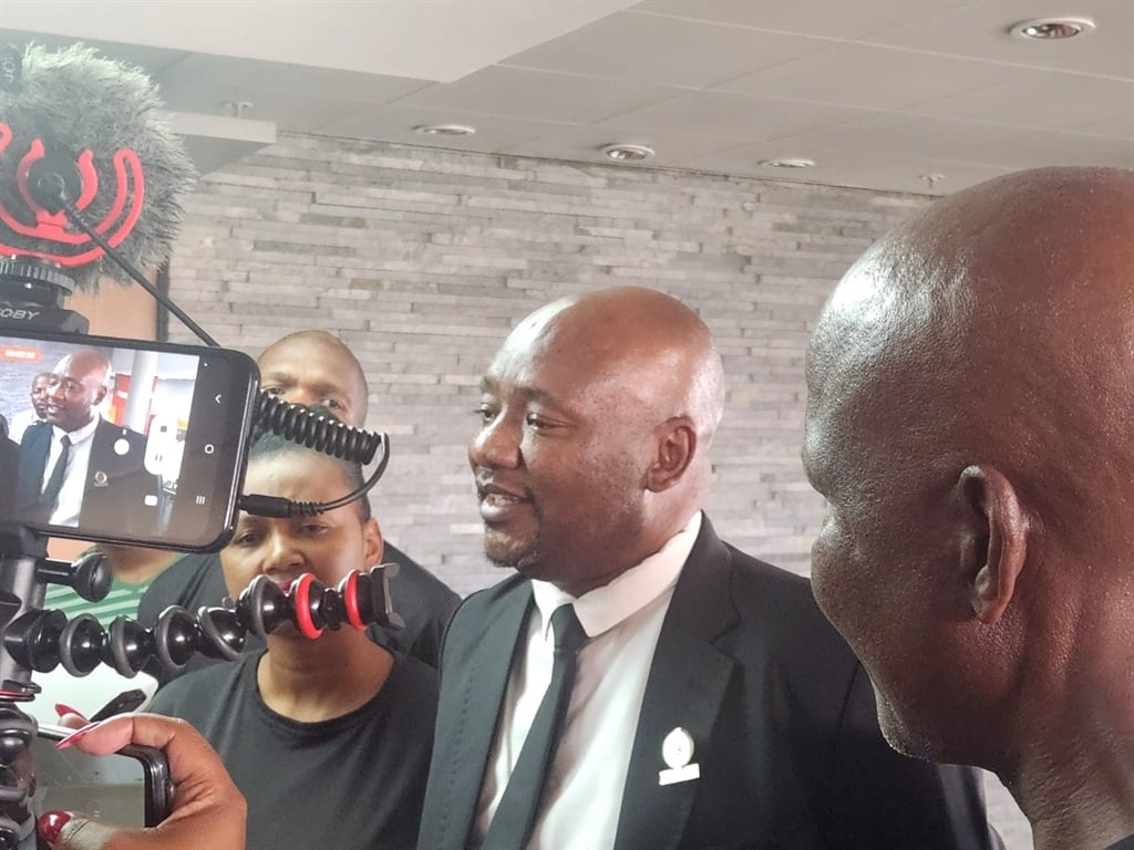 Former Ekurhuleni executive mayor Sivuyile Ngodwana speaks to media after he was booted from the mayor's seat. AIC Secretary General Themba Mhlongo is on the right in the foreground. (Alex Patrick/News24)