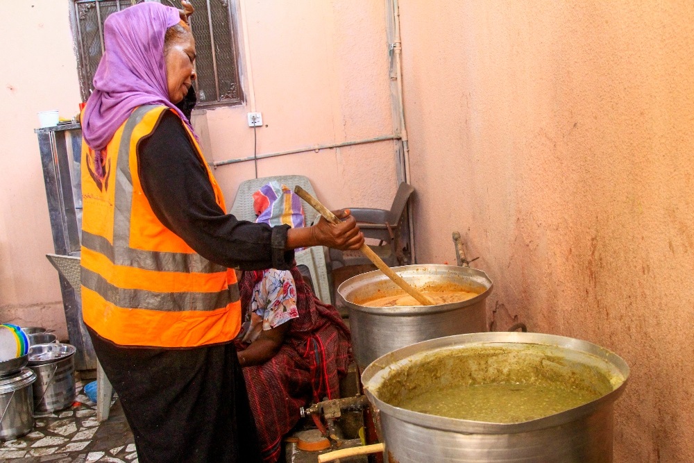 A volunteer cooks food for internally displaced Muslim devotees breaking fast meals during the Islamic holy month of Ramadan in Gedaref. (AFP)