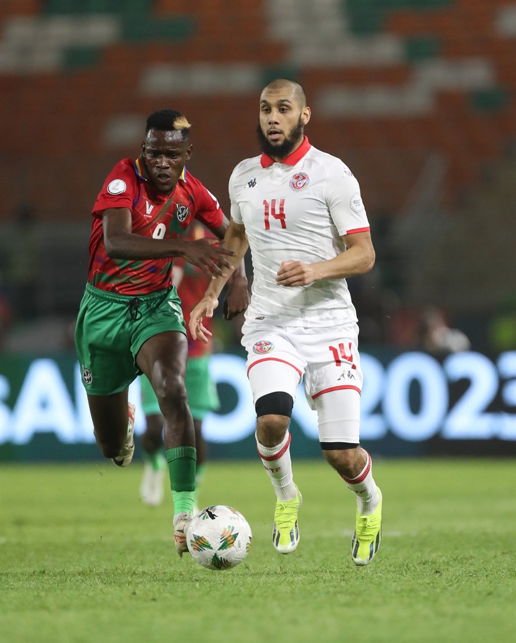 KORHOGO, IVORY COAST - JANUARY 16: Aissa LaÃ¯douni of Tunisia battles with Bethuel Muzeu of Namibia during the TotalEnergies CAF Africa Cup of Nations group stage match between Tunisia and Namibia at Amadou Gon Coulibaly Stadium on January 16, 2024 in Korhogo, Ivory Coast. (Photo by MB Media/Getty Images)