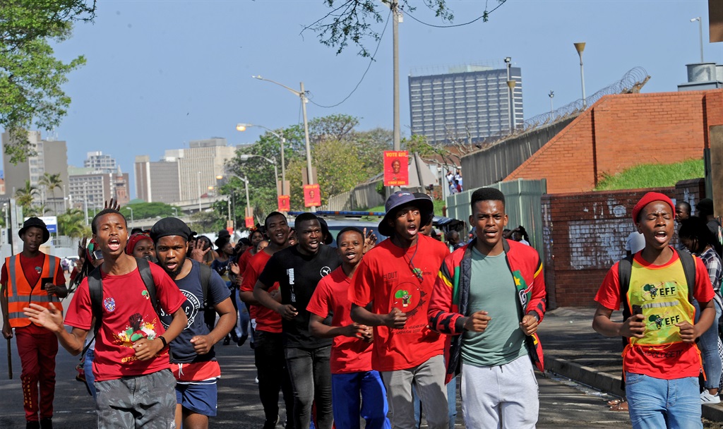 EFF Student Command members sing as they wait for the party's secretary-general, Marshall Dlamini, to arrive at Curries Fountain Sports Development Centre in Durban. Photo: Tebogo Letsie/City Press