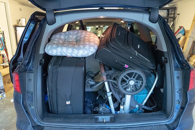 Rear view of open trunk of a minivan in suburban g
