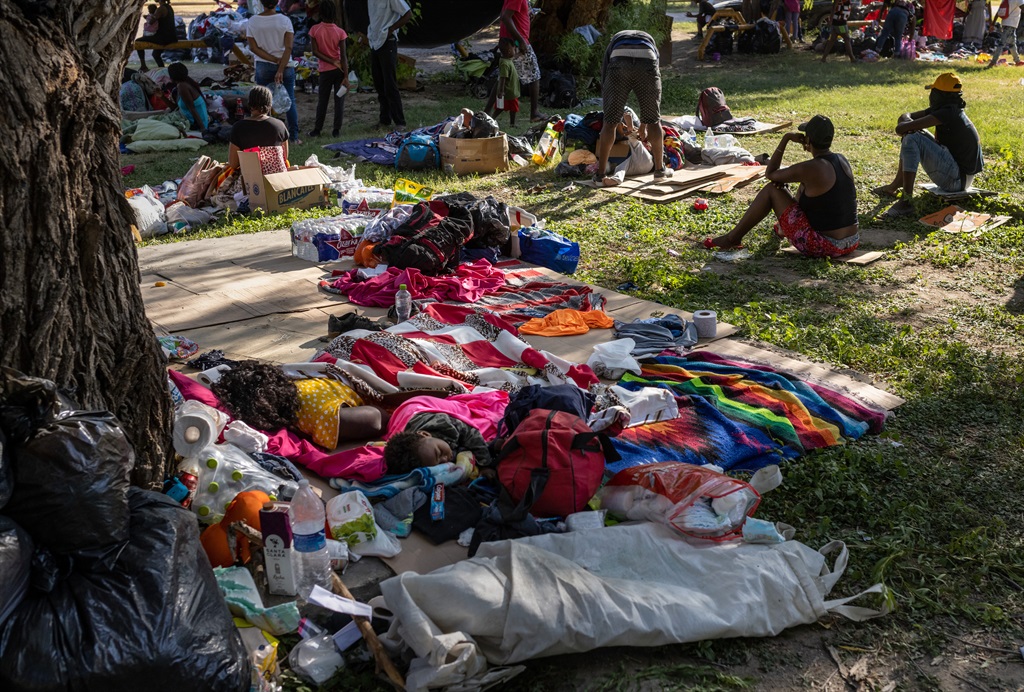 A mother and child sleep under a tree on September 22, 2021 in Ciudad Acuna, Mexico. U.S. immigration authorities have been deporting planeloads of migrants directly to Haiti, and others are reportedly being released into the United States to follow their asylum claims.  (Photo by John Moore/Getty Images)