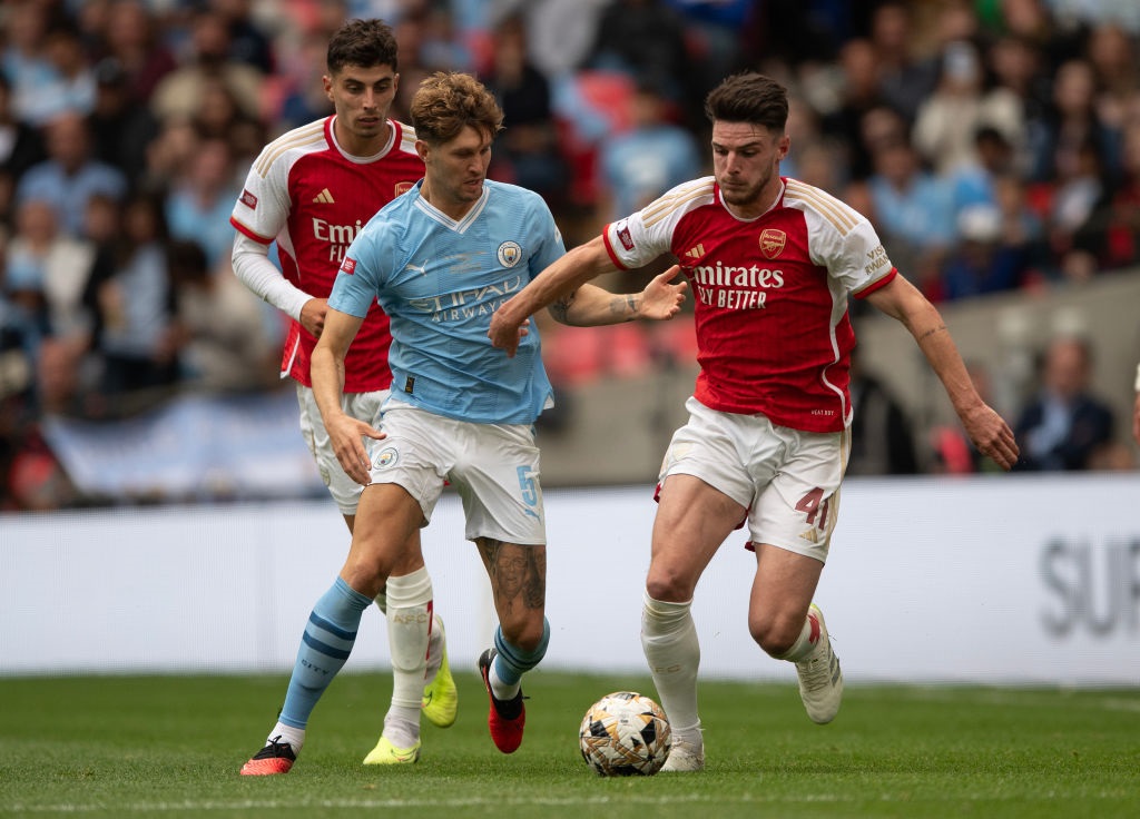 LONDON, ENGLAND - AUGUST 06:  John Stones of Manchester City battles with Declan Rice of Arsenal during The FA Community Shield match between Manchester City against Arsenal at Wembley Stadium on August 06, 2023 in London, England. (Photo by Visionhaus/Getty Images)
