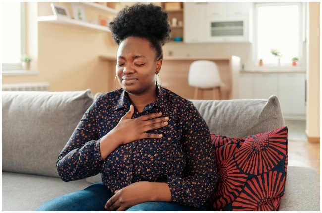 Woman experiencing chest pains.