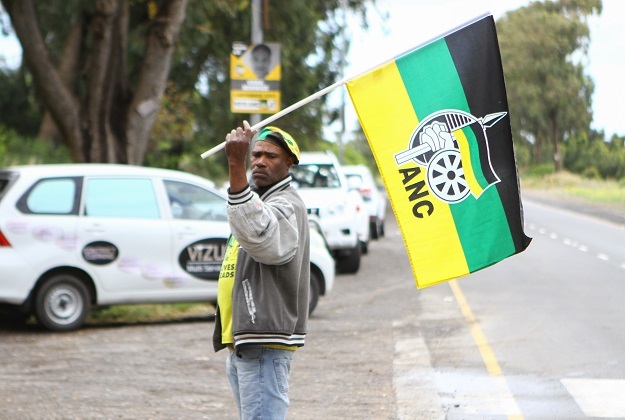 An ANC supporter waves a flag in Cape Town on voting day.