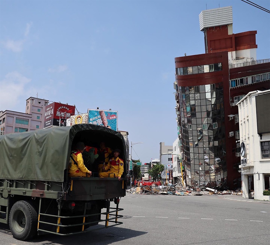 Military personnel arriving to aid in rescue and relief efforts on 3 April 2024 at the site of a damaged building in Hualien, after a major earthquake hit Taiwan's east. (Taiwan's Central News Agency/AFP)