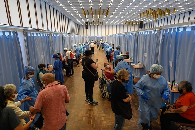 People wait to receive the first dose of the Sputnik V vaccine against Covid-19 in Caracas.
