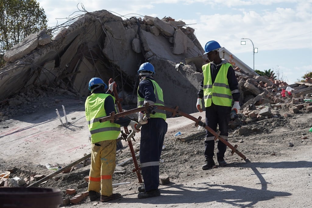 Rescue workers have turned their efforts to stairwells and parking areas of a collapsed construction site to find 39 missing workers. (Luke Daniel/News24)