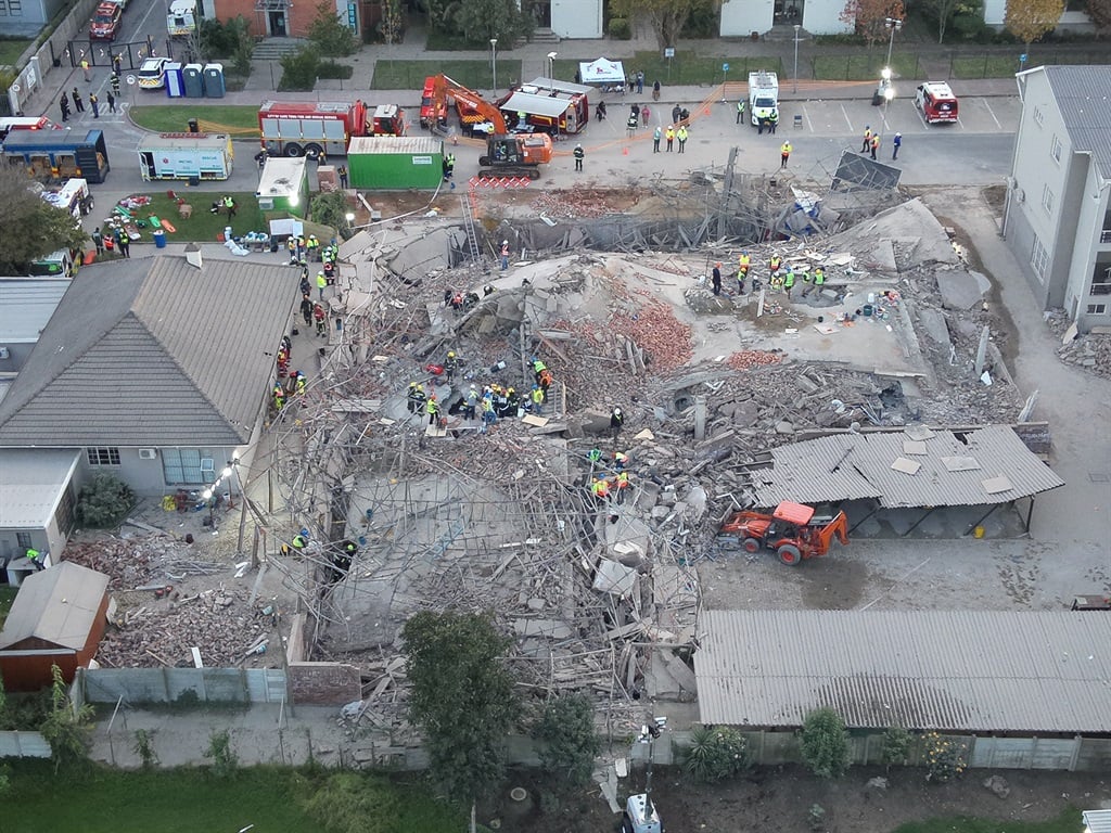 Drone images of rescue teams as they search for victims in the collapsed construction site. (Supplied/George Municipality)