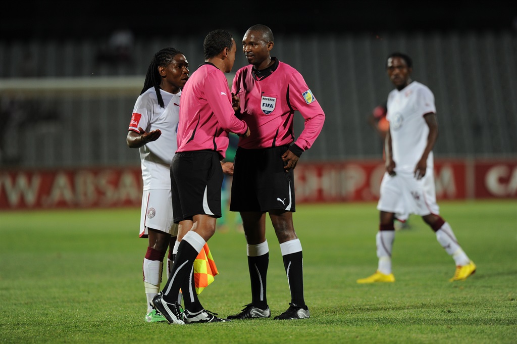DOBSONVILLE, SOUTH AFRICA - NOVEMBER 18, Referee Lwandile Mfiki listen to Emmanuel de Sanis comment about a disallowed goal during the Absa Premiership match between Moroka Swallows and Bloemfontein Celtic from Volkswagen Dobsonville Stadium on November 18, 2011 in Dobsonville, South Africa