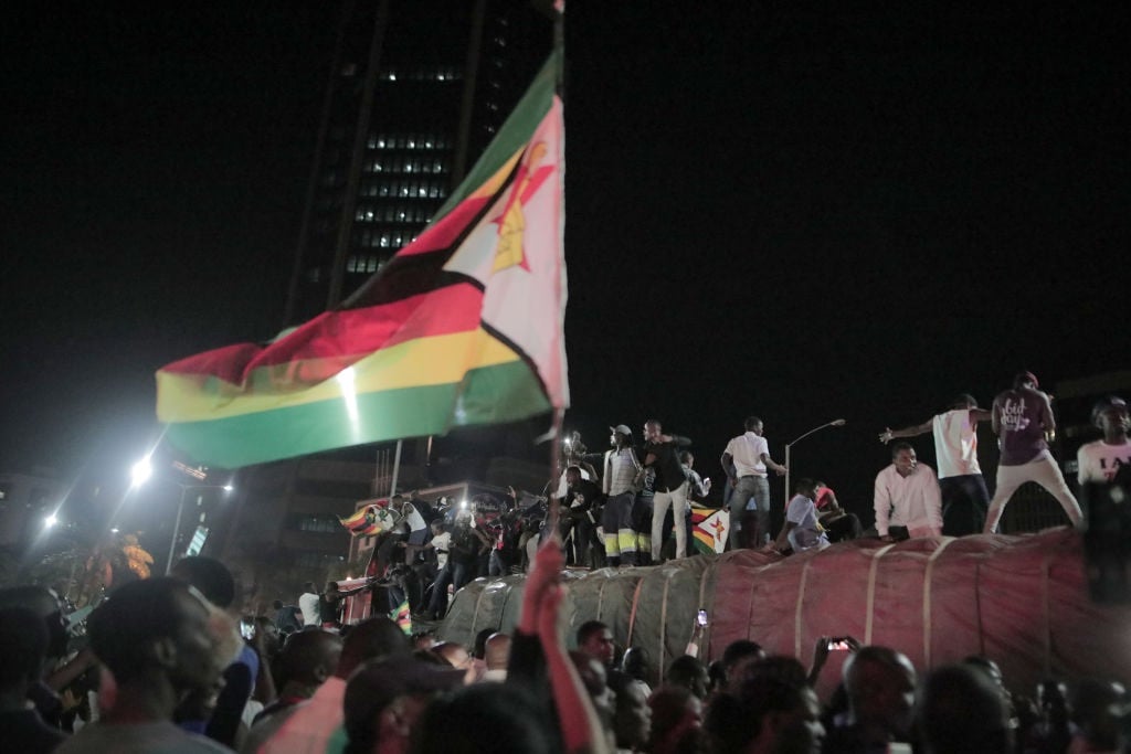 Zimbabweans drink, sing, and dance as they celebra