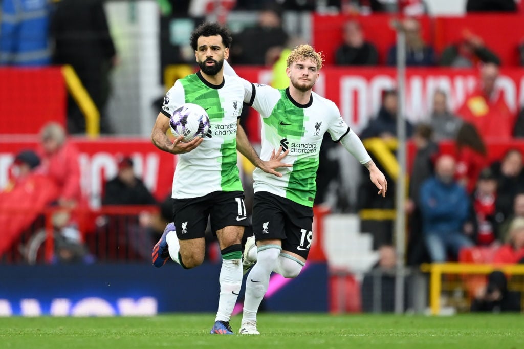 MANCHESTER, ENGLAND - APRIL 07: Mohamed Salah of Liverpool (L) celebrates scoring his teams second goal from the penalty spot with teammate Harvey Elliott during the Premier League match between Manchester United and Liverpool FC at Old Trafford on April 07, 2024 in Manchester, England. (Photo by Shaun Botterill/Getty Images)