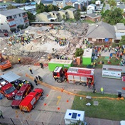 George building collapse: Heavy machinery, cranes roll in to assist with 'slow, careful' rescue